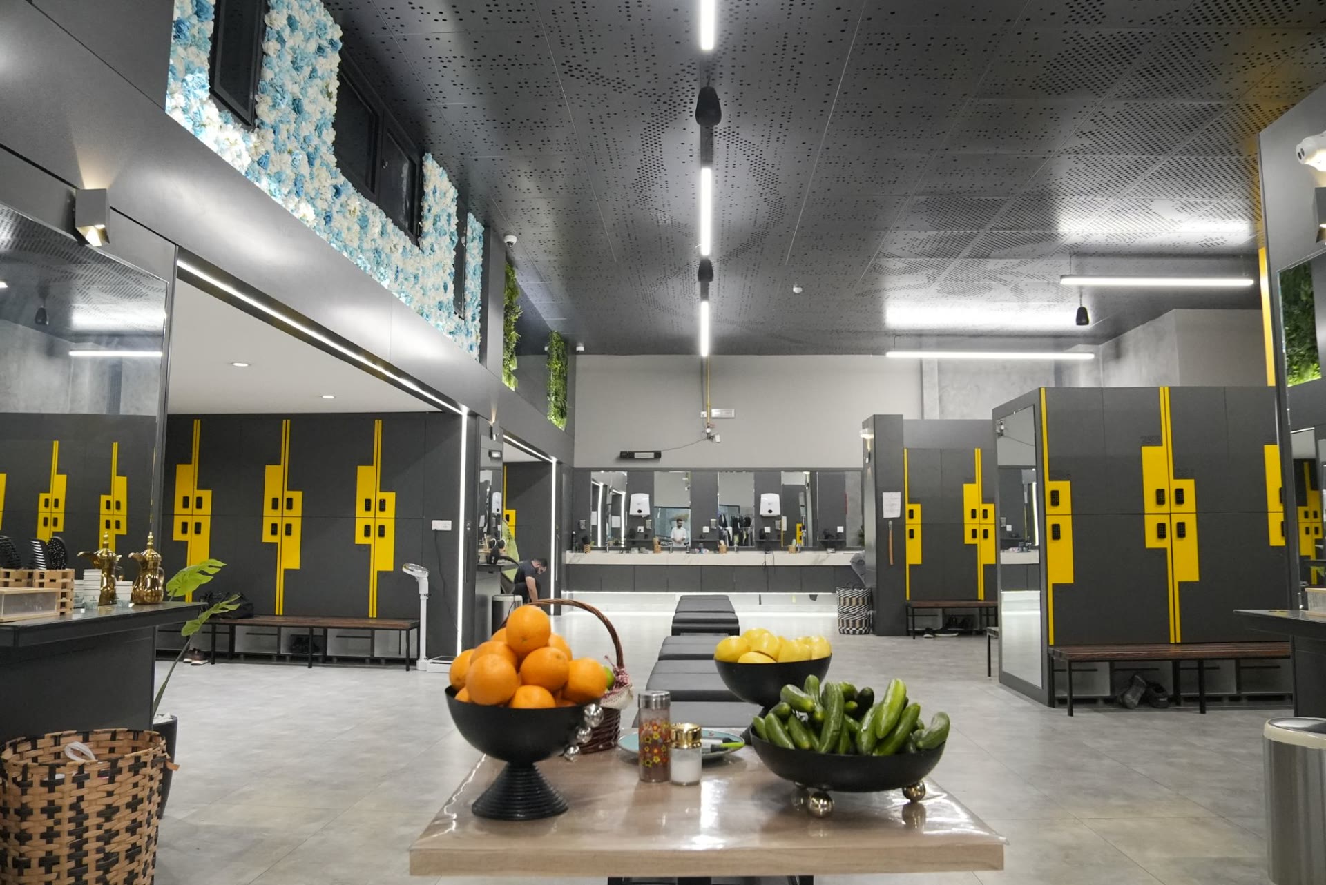 The locker room with yellow lockers and bowls of fresh fruit