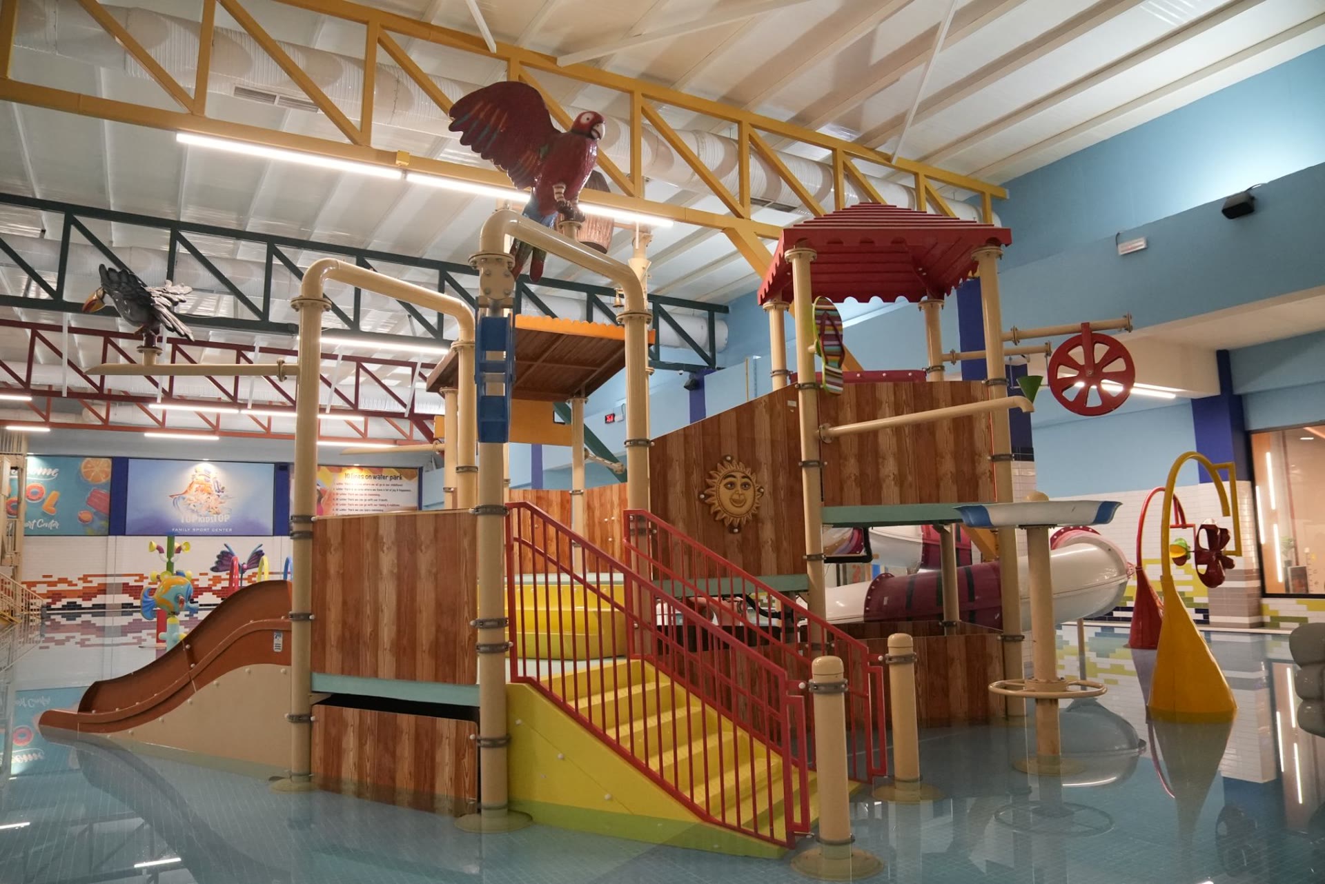 The kids' water park with slides and a parrot on the tower